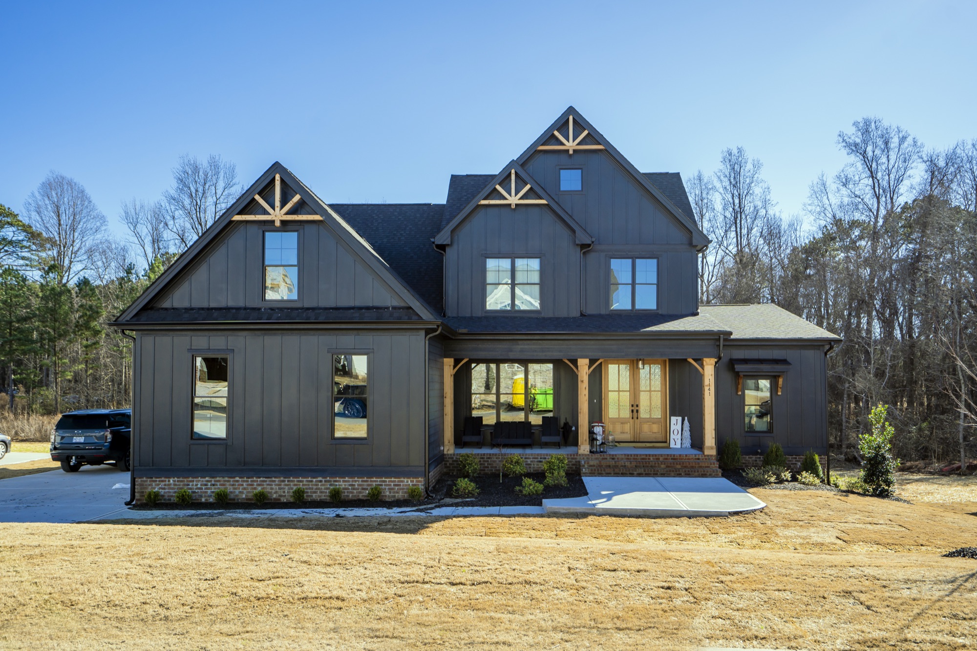 The Onyx, a Gemstone custom home with a black board-and-batten exterior