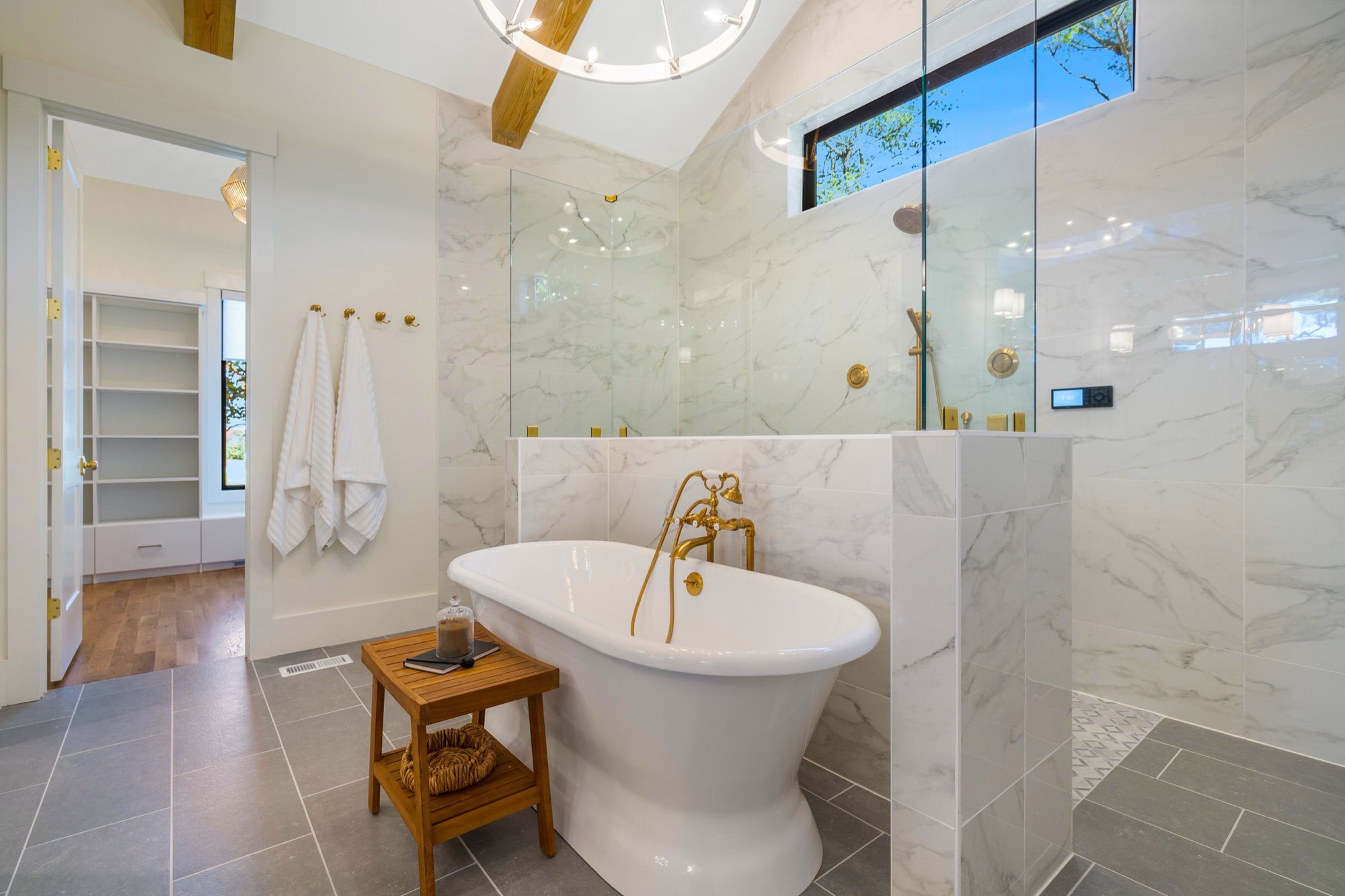 Master bathroom with marble and freestanding tub
